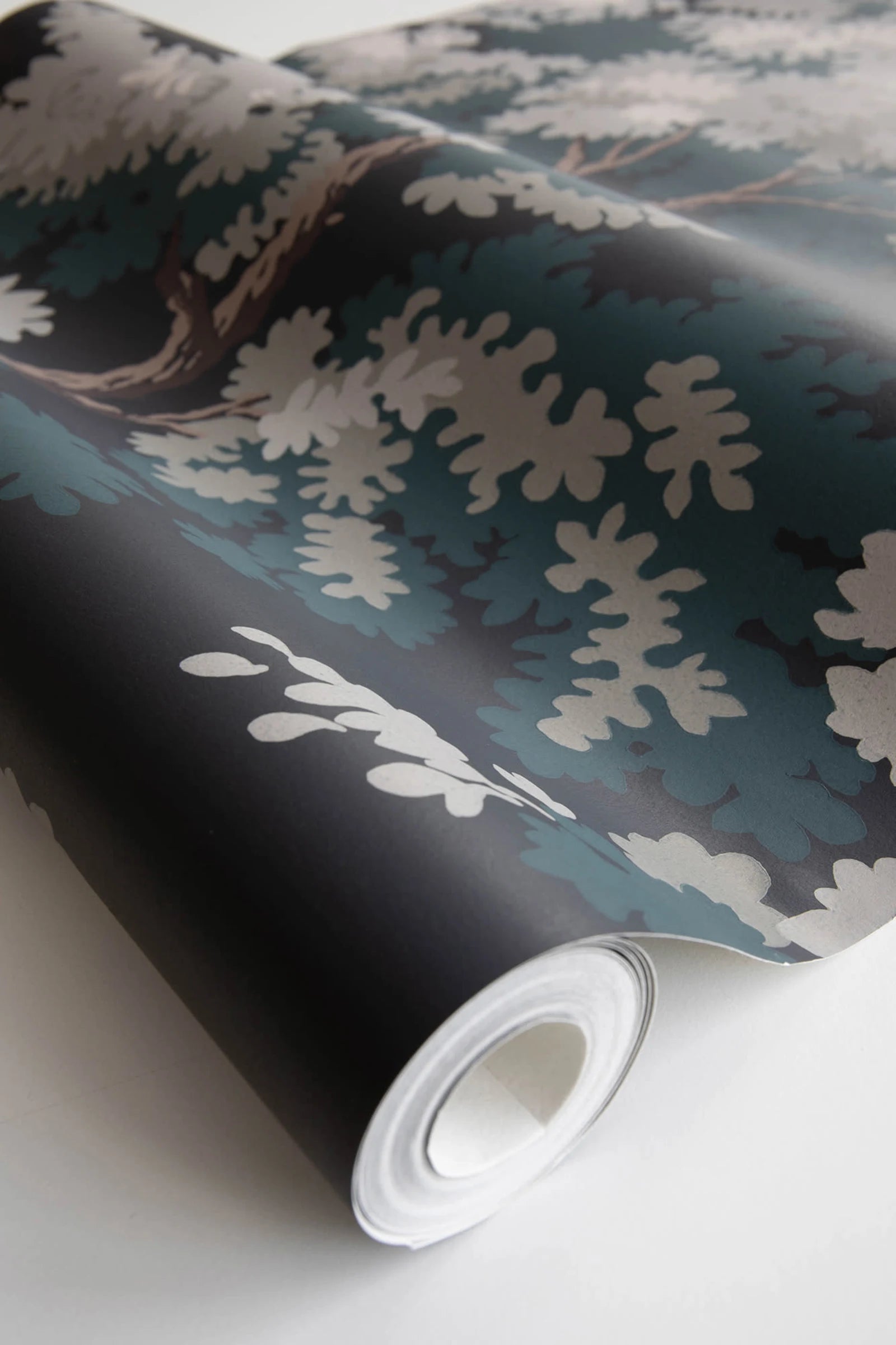 Raphael wallpaper by Sandberg, close-up of a part-rolled roll in the dark green and black oak-tree print