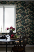 Raphael wallpaper by Sandberg in dark green oak-tree print in a dining nook with a black table and bright peonies