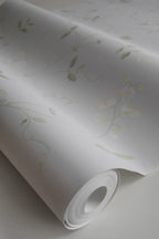 Sanna Sweet Pea wallpaper by Sandberg, close-up of a part-rolled roll showing the delicate cream sweet pea vines