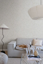 Sanna Sweet Pea wallpaper by Sandberg in soft cream sweet pea print in a living room with a linen sofa and ginger cat