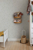 Sanna Sweet Pea wallpaper by Sandberg in pale grey sweet pea print in a nursery with a wicker shelf of soft toys