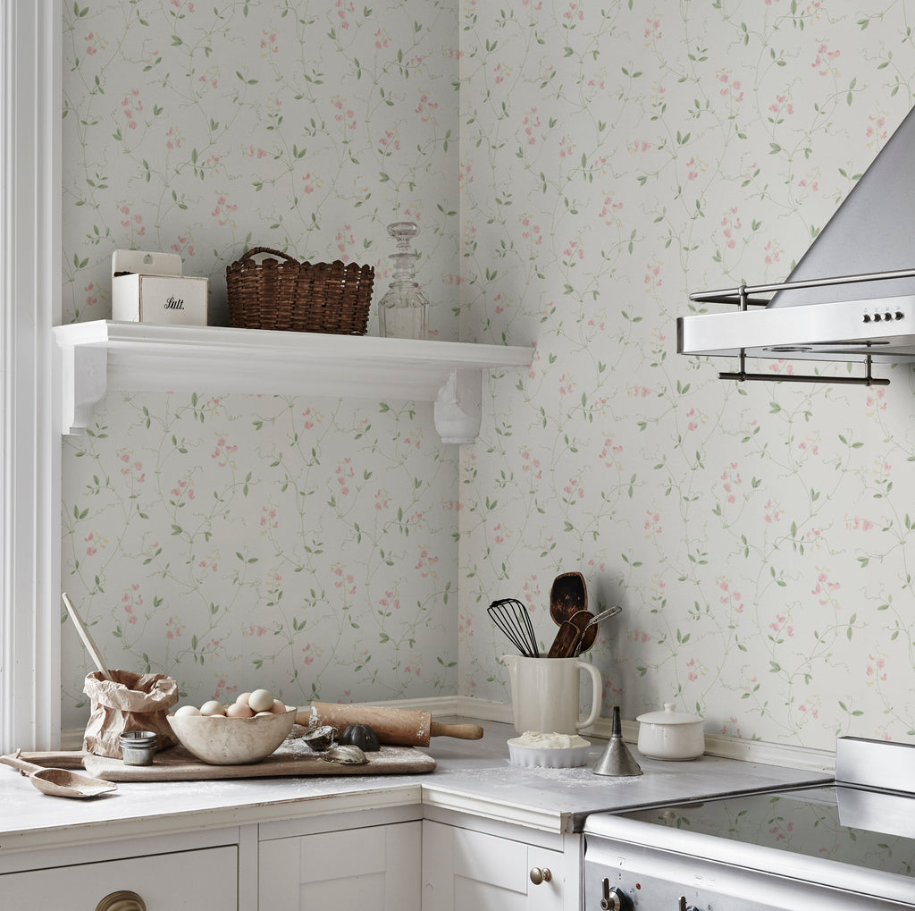 Sanna Sweet Pea wallpaper by Sandberg in white with pink sweet pea blooms in a kitchen corner with open shelf