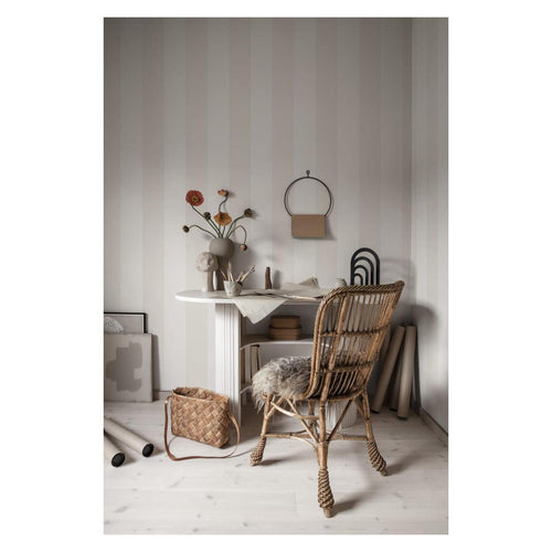 Soft greige Magnus Stripe wallpaper by Sandberg behind a white desk and rattan chair in a calm study nook