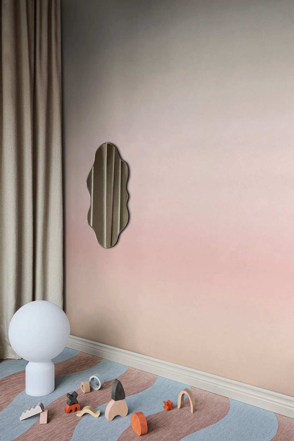 Skymning wall mural by Sandberg, grey-to-blush ombré sky styled in a corner with linen curtain and wavy mirror