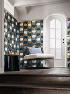 Dauphine wallpaper by Casamance in navy, white and gold on slate blue, styled behind a wire day bed with a sheepskin seat and grey cushion