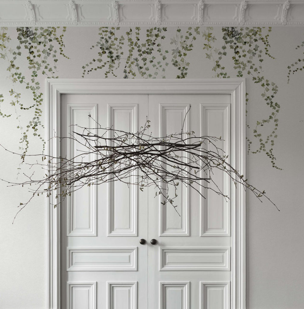 Aralia wallpaper by Sandberg in Moss Green, styled on an interior wall