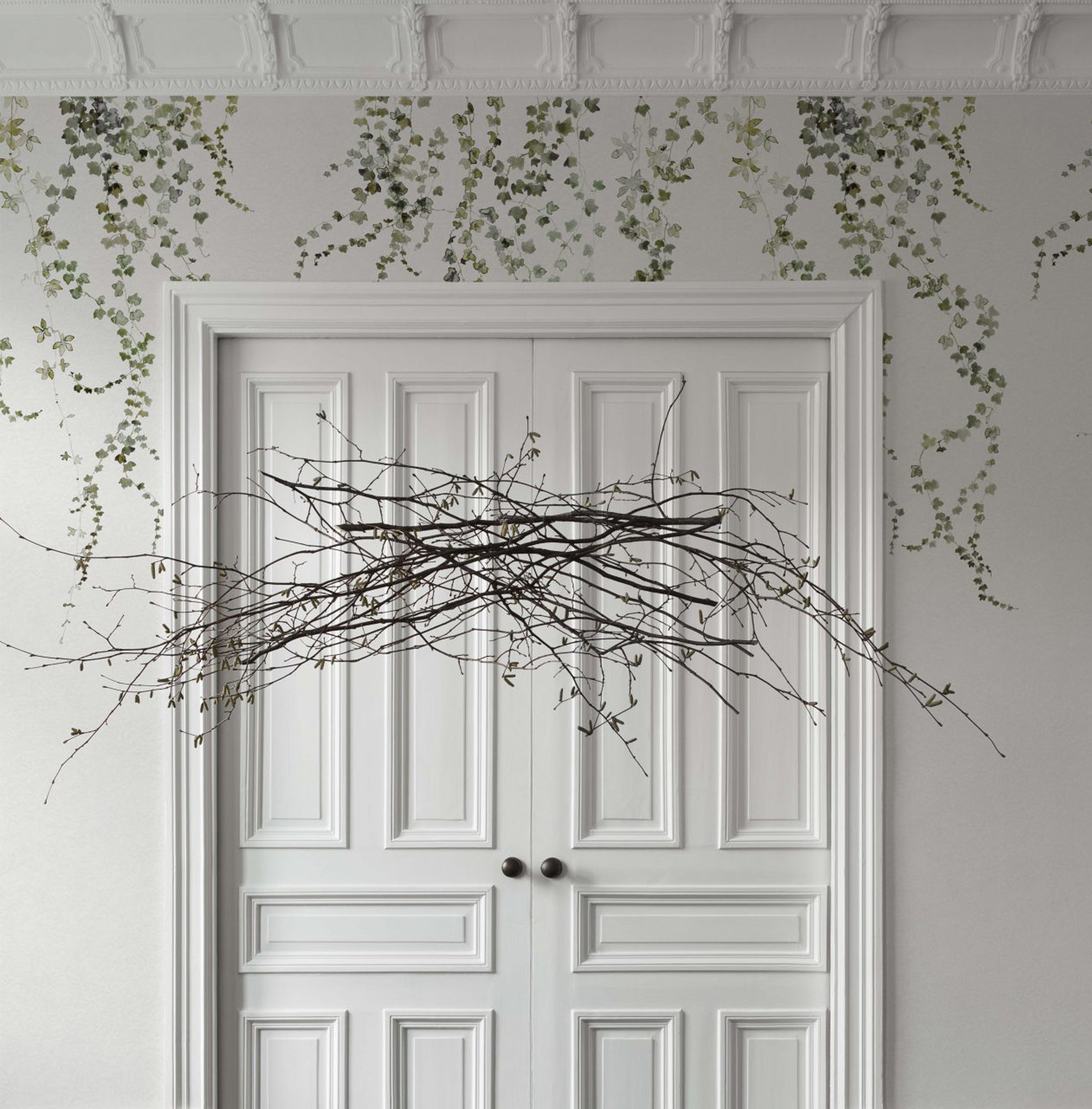 Aralia wallpaper by Sandberg in Moss Green, styled on an interior wall