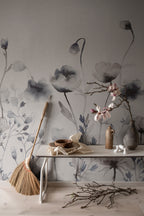 Morängen Floral wall mural by Sandberg in grey-blue behind a console table with magnolia branches and rustic pottery