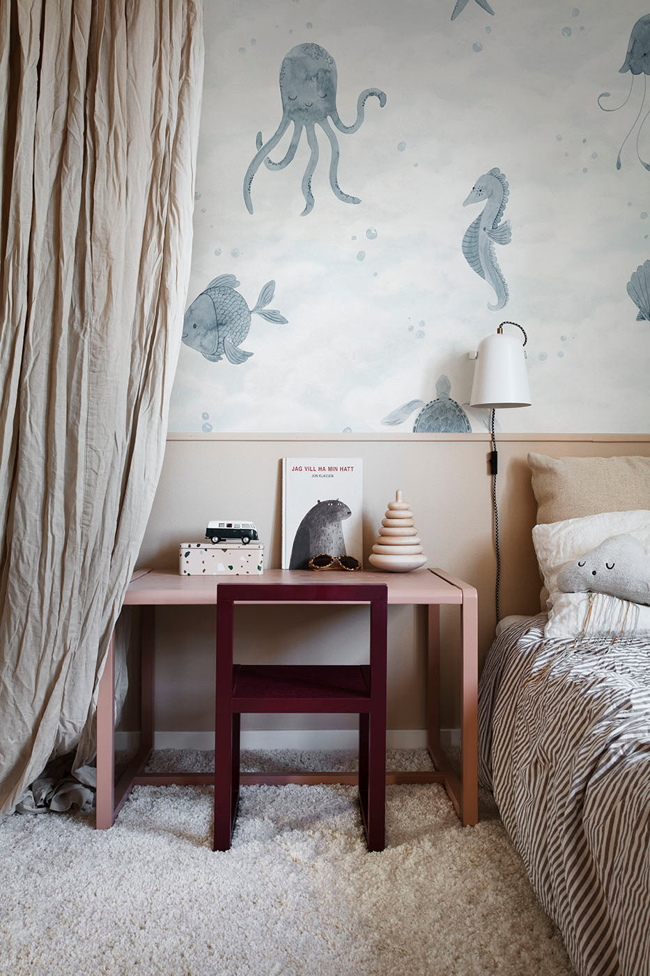 Alice Underwater wall mural by Sandberg in blue, octopus, seahorse and fish above a pink desk in a kids room