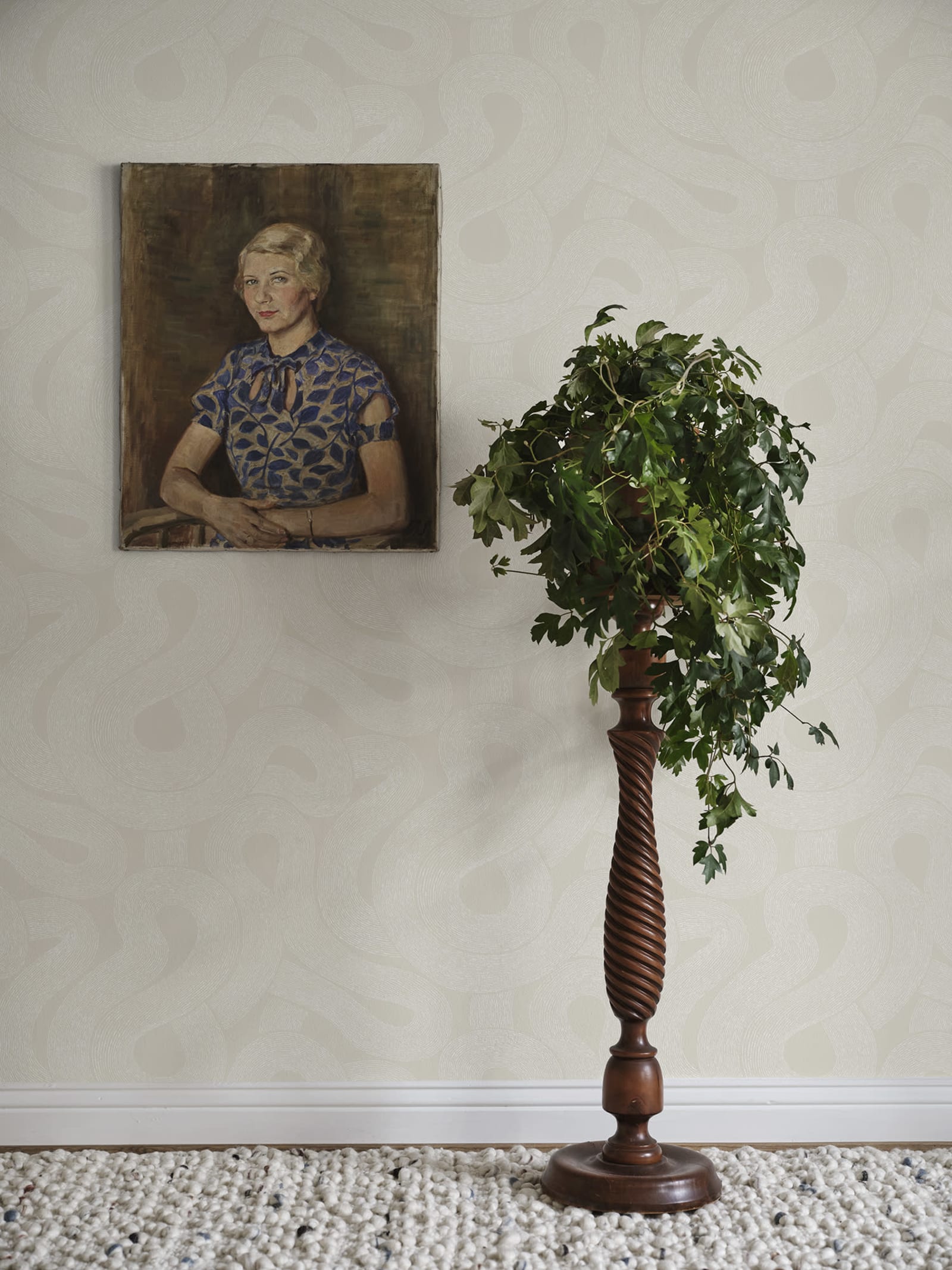 Zen wallpaper by Sandberg in soft beige tonal looping print beside a portrait painting and a tall plant stand
