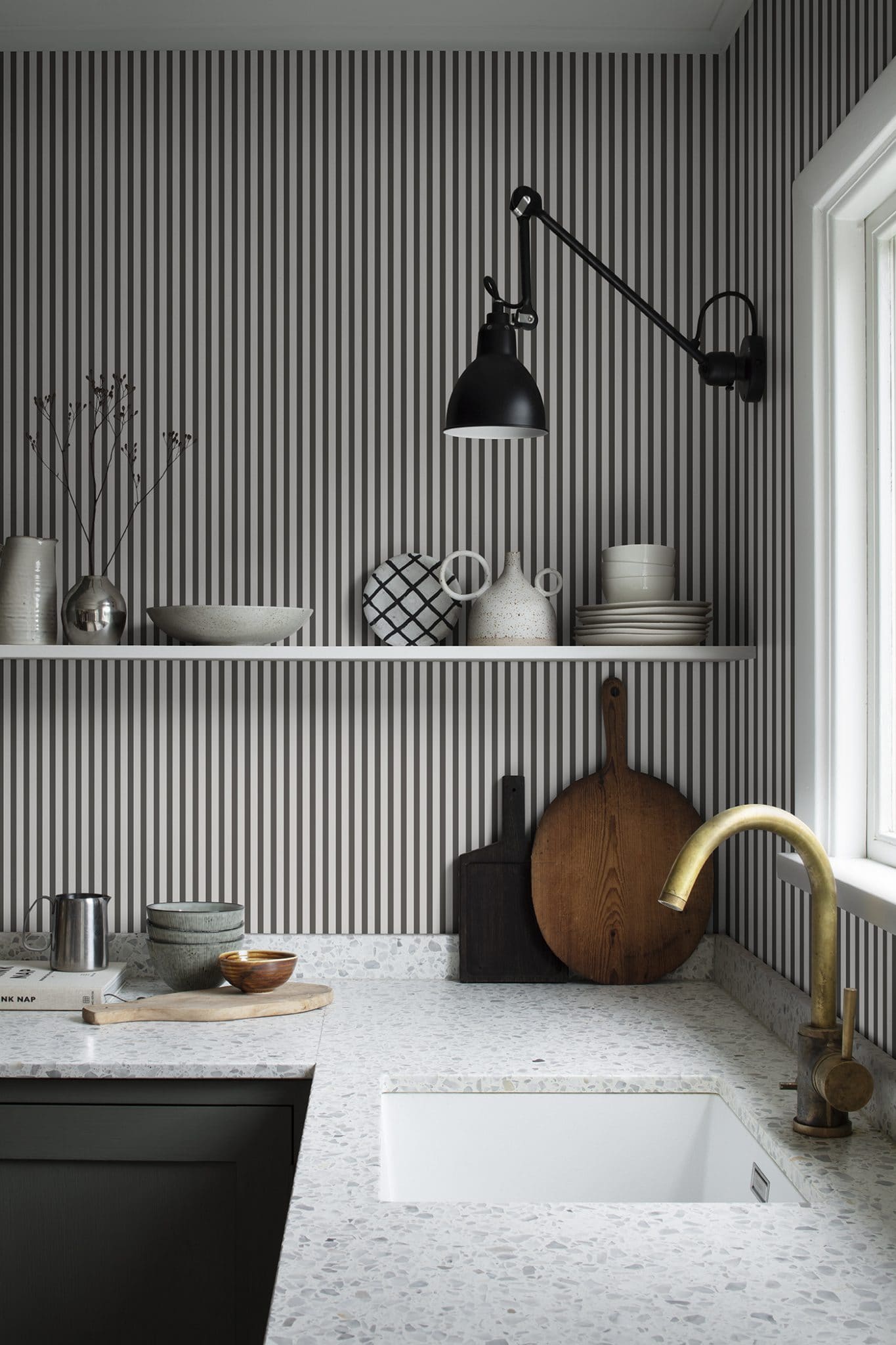 Estelle wallpaper by Sandberg in Graphite, styled on an interior wall