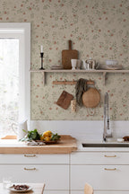 Henny wallpaper by Sandberg in a country kitchen, coral floral vine on sage behind open shelving and a sink