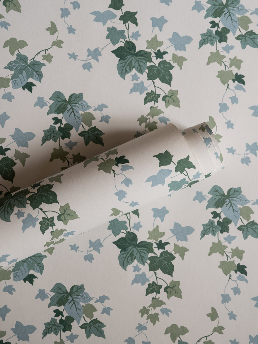 Ivy wallpaper by Långelid/von Brömssen in Green – botanical design, a part-rolled length showing the ivy leaves