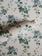 Ivy wallpaper by Långelid/von Brömssen in Green – botanical design, a part-rolled length showing the ivy leaves