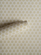 India wallpaper by Långelid/von Brömssen in Yellow – floral design, a part-rolled length showing the block-print flower