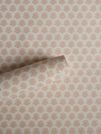 India wallpaper by Långelid/von Brömssen in Peach – floral design, a part-rolled length showing the block-print flower