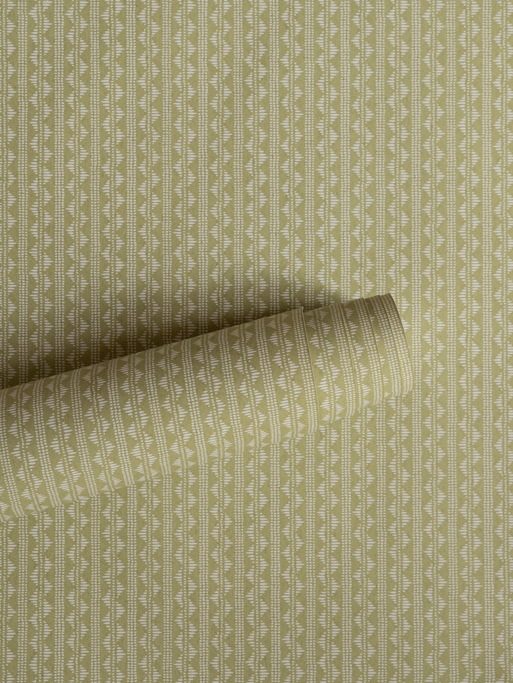 Zigzag wallpaper by Långelid/von Brömssen in Green – Dusty Lemon – geometric design, a part-rolled length showing the woven zigzag