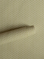 Zigzag wallpaper by Långelid/von Brömssen in Green – Dusty Lemon – geometric design, a part-rolled length showing the woven zigzag