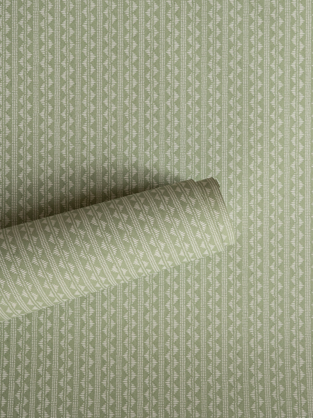 Zigzag wallpaper by Långelid/von Brömssen in Green – Laurel – geometric design, a part-rolled length showing the woven zigzag