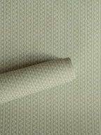 Zigzag wallpaper by Långelid/von Brömssen in Green – Laurel – geometric design, a part-rolled length showing the woven zigzag