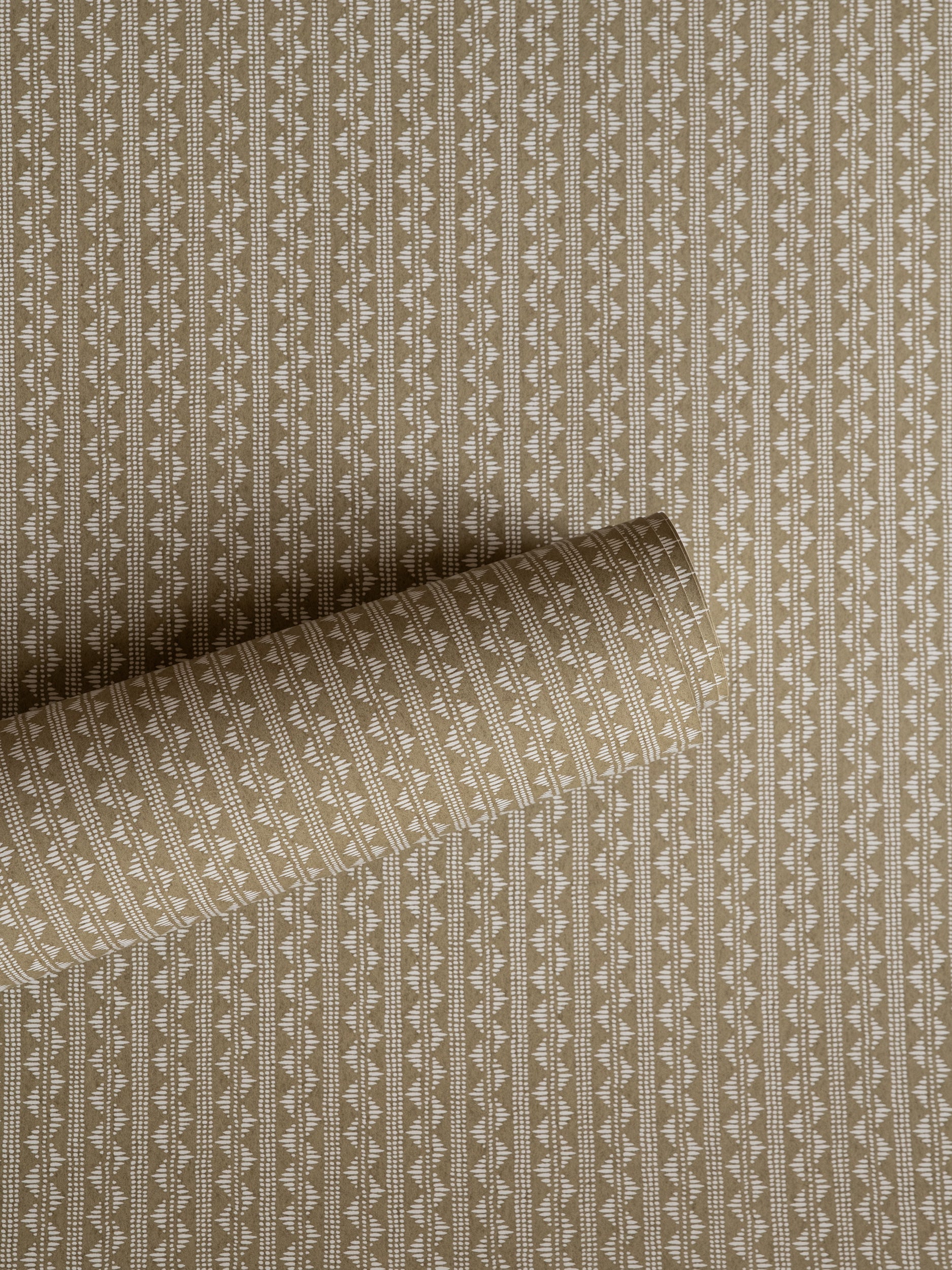 Zigzag wallpaper by Långelid/von Brömssen in Beige – geometric design, a part-rolled length showing the woven zigzag