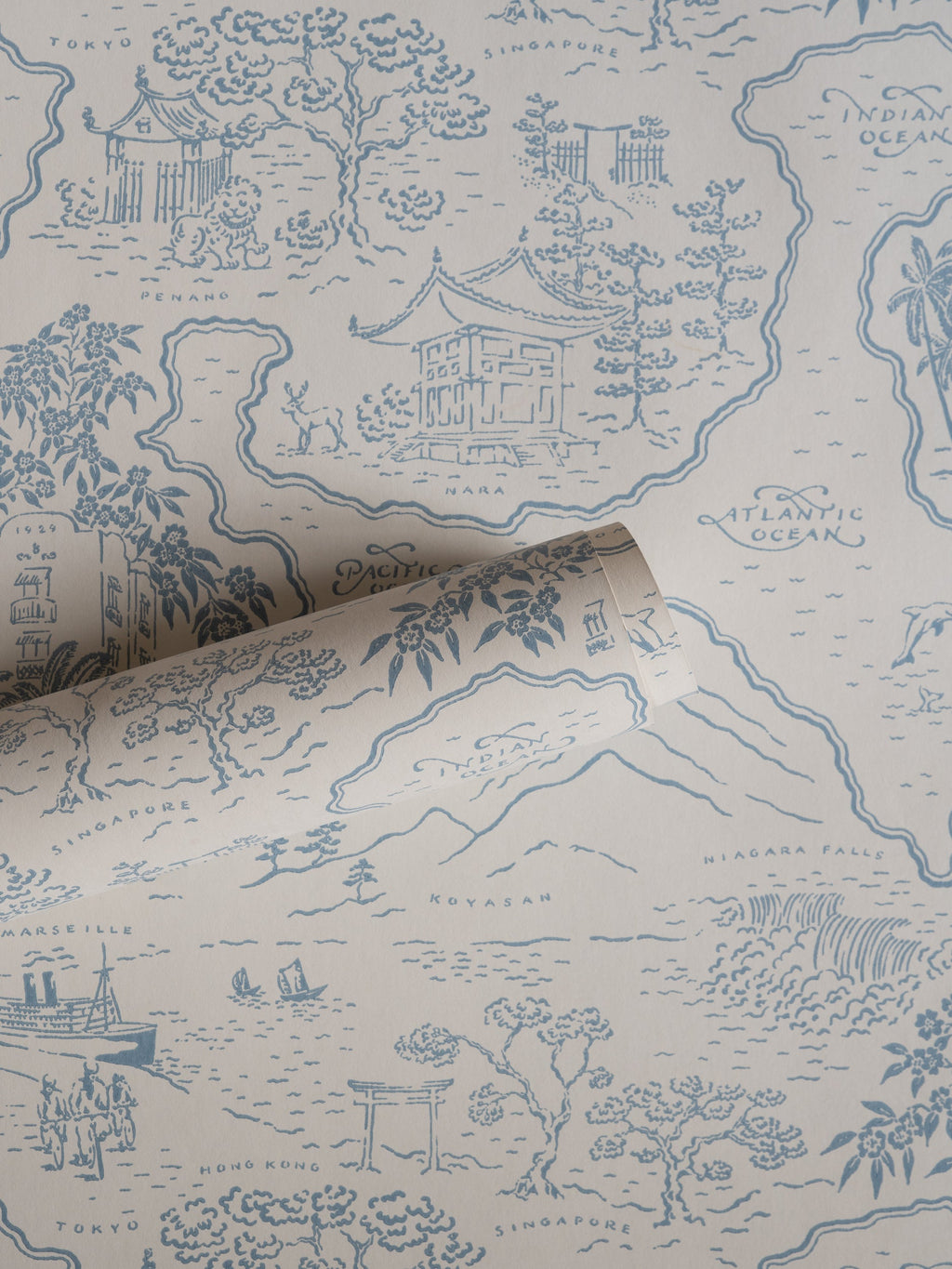 Voyage 1929 wallpaper by Långelid/von Brömssen in Blue – coastal design, a part-rolled length showing the map motif