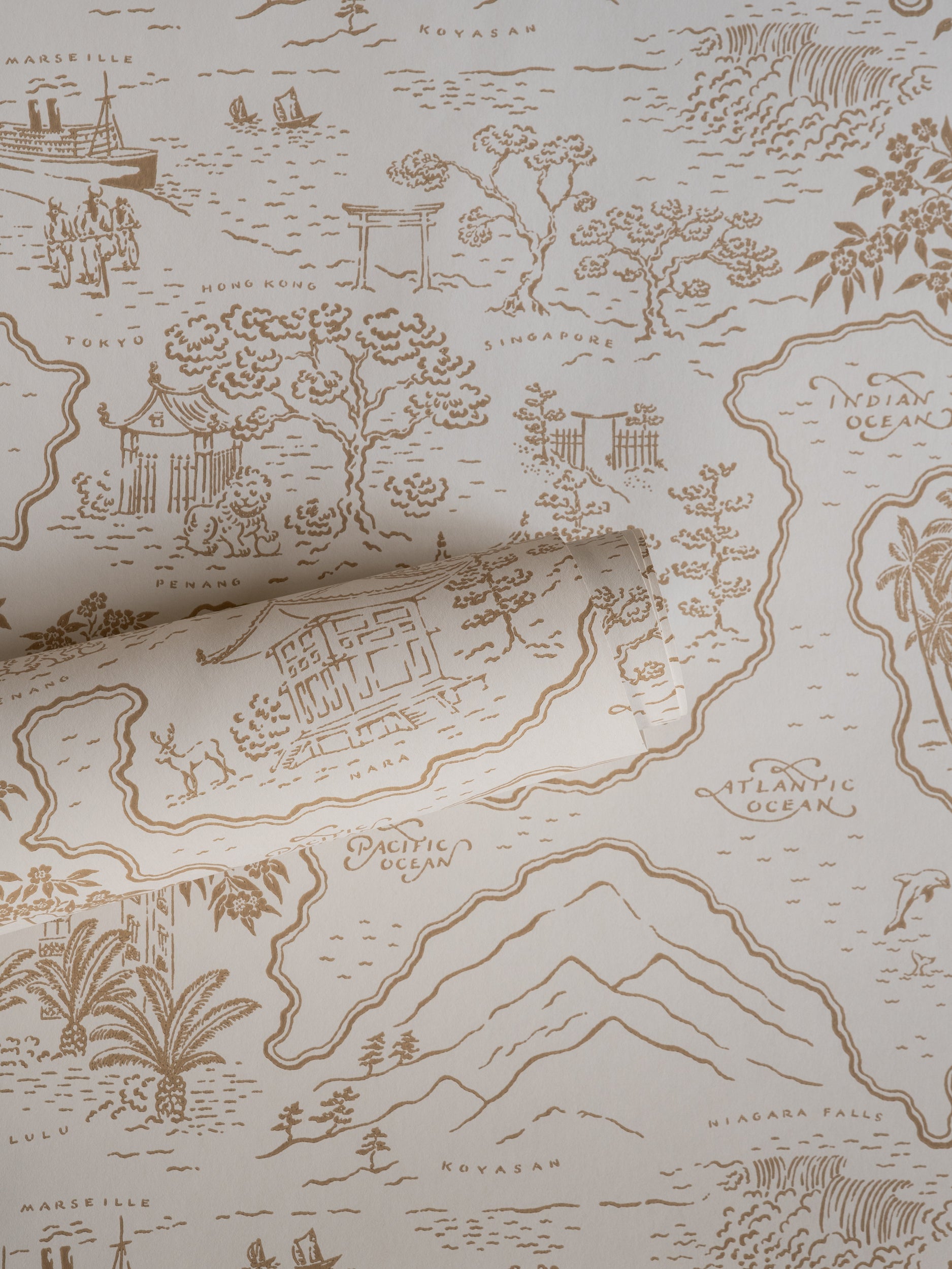 Voyage 1929 wallpaper by Långelid/von Brömssen in Orange – coastal design, a part-rolled length showing the map motif