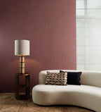 Flamant Terre de Lin wallpaper by Arte in Red behind a curved cream sofa and a brass side table