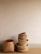 India wallpaper by Långelid/von Brömssen in Peach – floral design, with a stack of woven baskets