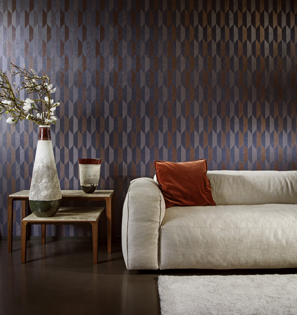 Arrow wallpaper by Arte in Blue behind a cream sofa with a rust cushion