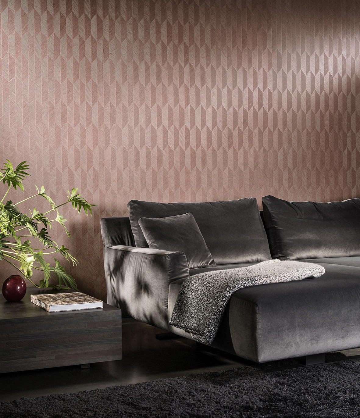 Symbol wallpaper by Arte in Pink behind a grey velvet sofa