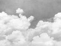 Fluffy Clouds wall mural by Rebel Walls, flat swatch of white clouds against a muted grey sky