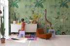 Giraffe's Stroll wallpaper by Rebel Walls in Green, styled on an interior wall