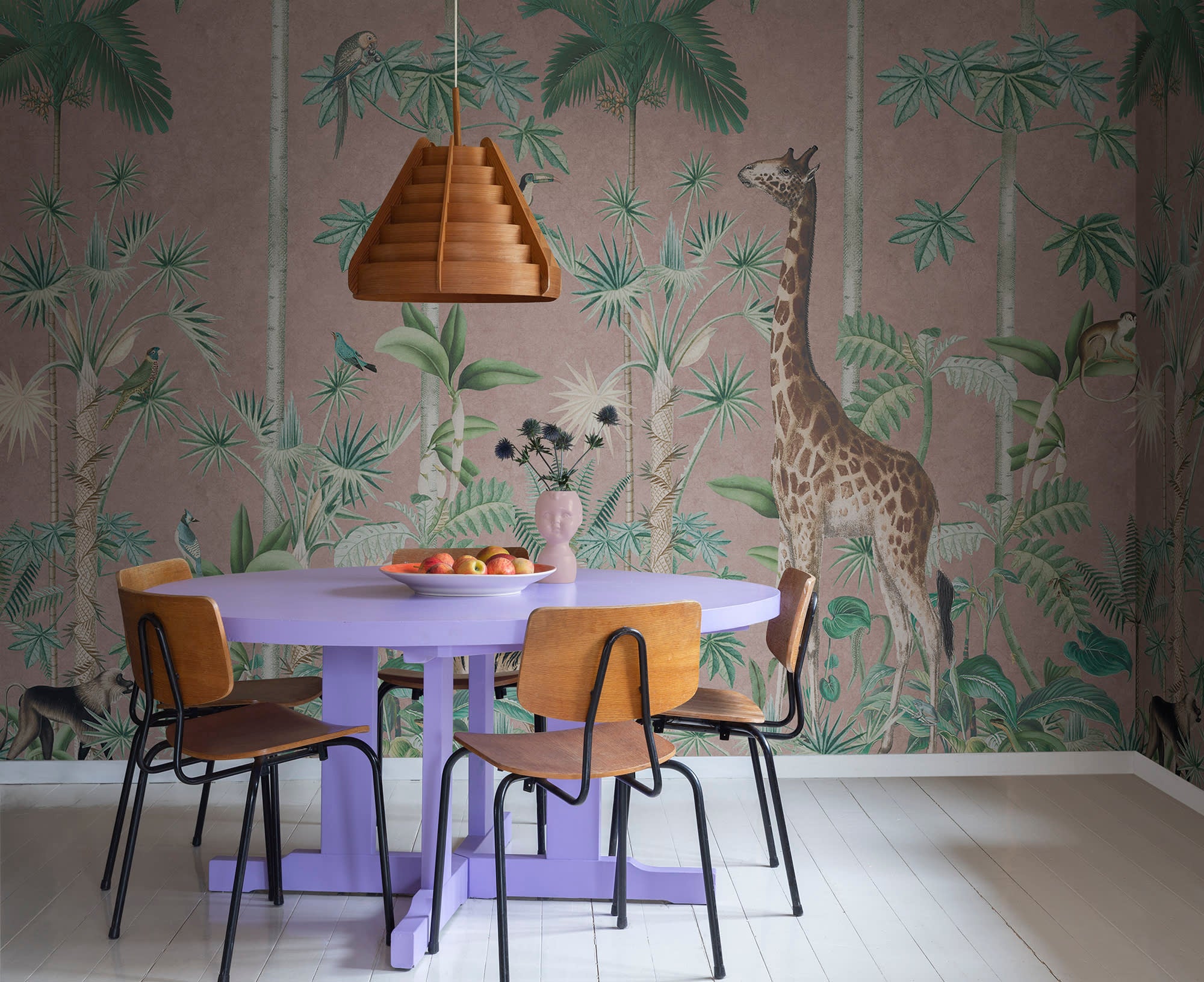 Giraffe's Stroll wallpaper by Rebel Walls in Pink, styled on an interior wall