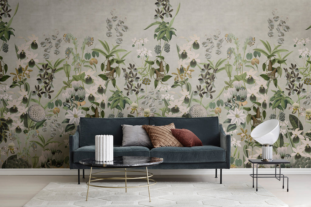 Alice's Garden Mural by Rebel Walls in green colourway behind a teal sofa in a living room