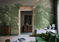 Spring Season wall mural by Rebel Walls in soft green, etched treetops styled around a marble doorway and antique chest