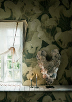 Corals wall mural by Rebel Walls in sage green, in a room with linen-draped window and shell wall art