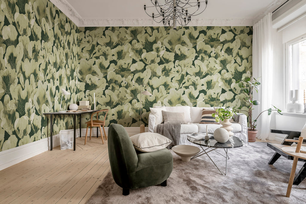 Corals wall mural by Rebel Walls in sage green, in a bright living room with green armchair and white sofa
