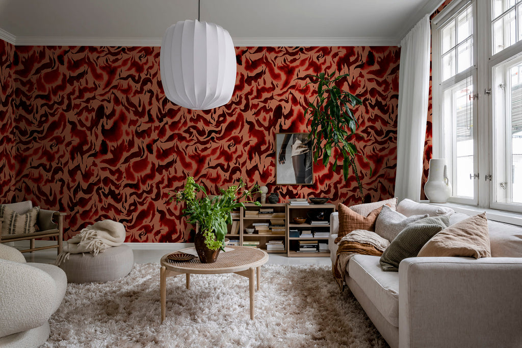 Discus Fish wall mural by Rebel Walls in red and coral swirls, in a bright living room with cream sofa and shaggy rug