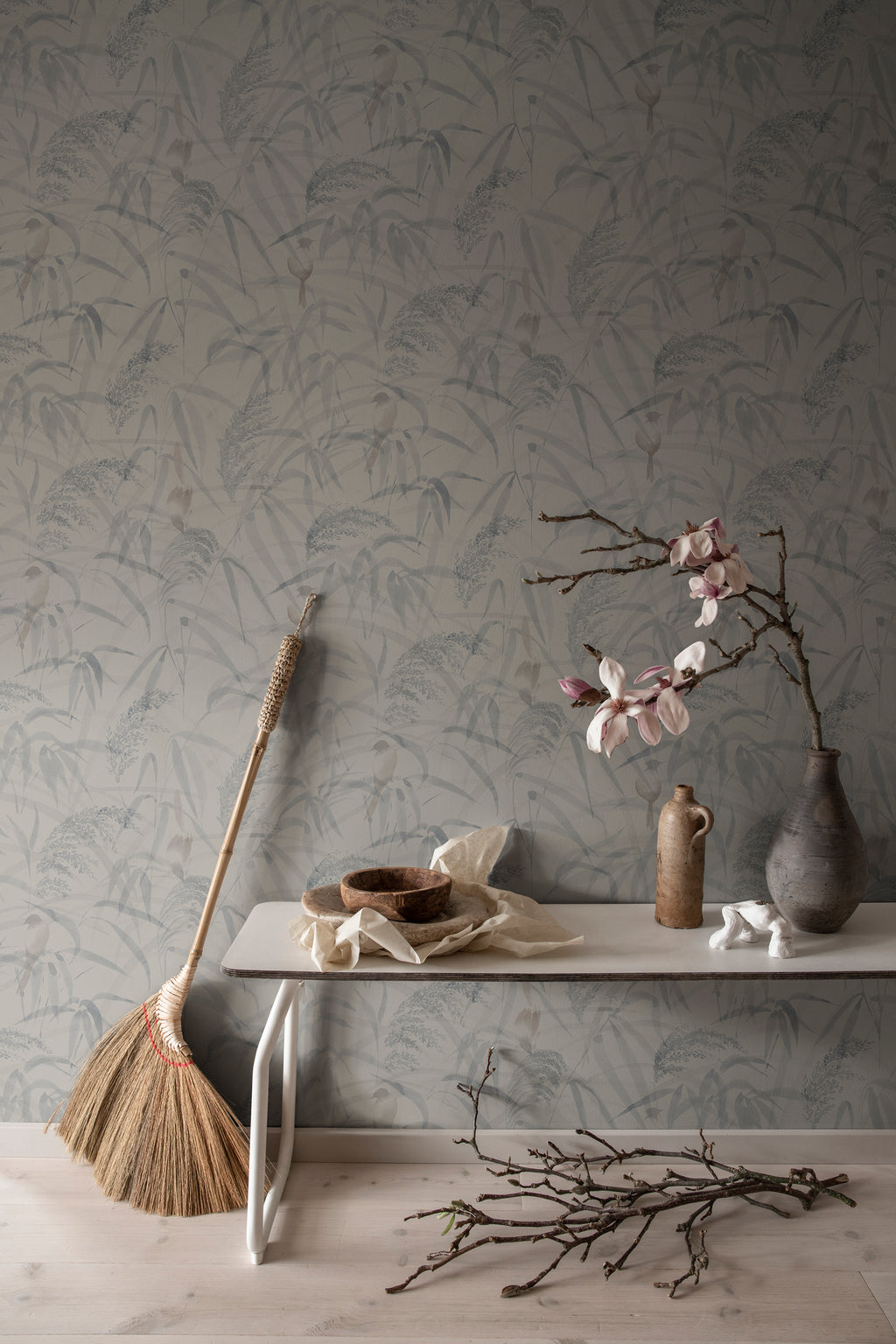 Anna wallpaper by Sandberg in Misty Blue, styled on an interior wall