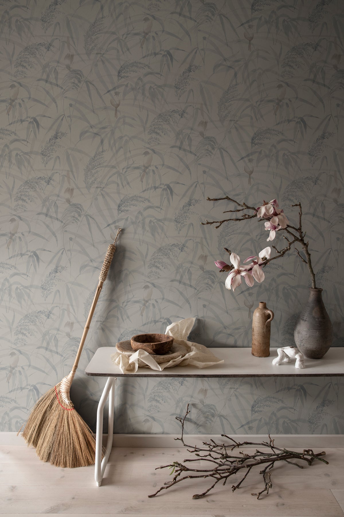 Anna wallpaper by Sandberg in Misty Blue, styled on an interior wall