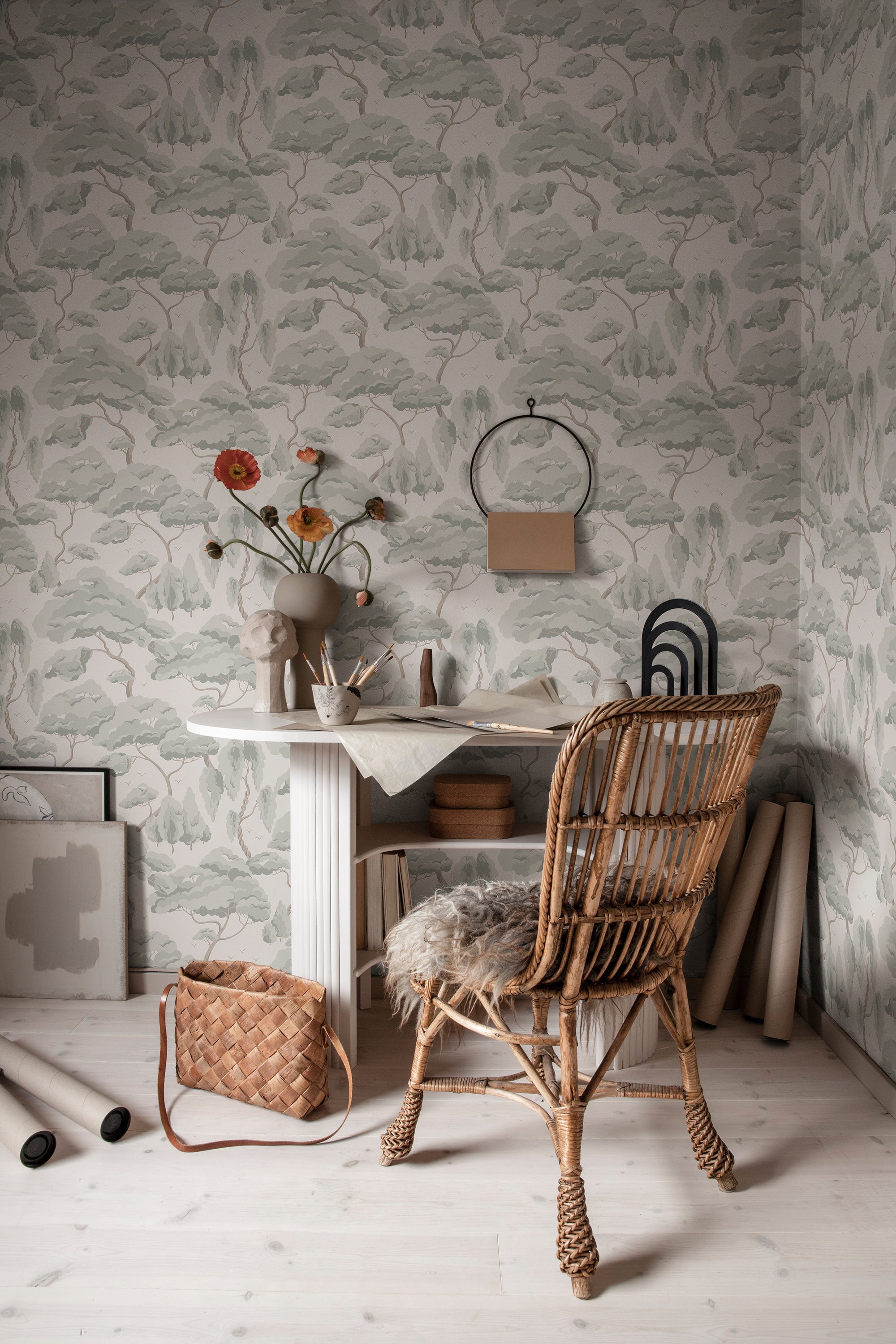 Sage Kristoffer Forest wallpaper by Sandberg behind a white desk and rattan chair with poppies in a studio nook