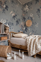 Faded Passion wall mural by Sandberg in dusty blue-grey behind a childs rattan daybed and bookshelf