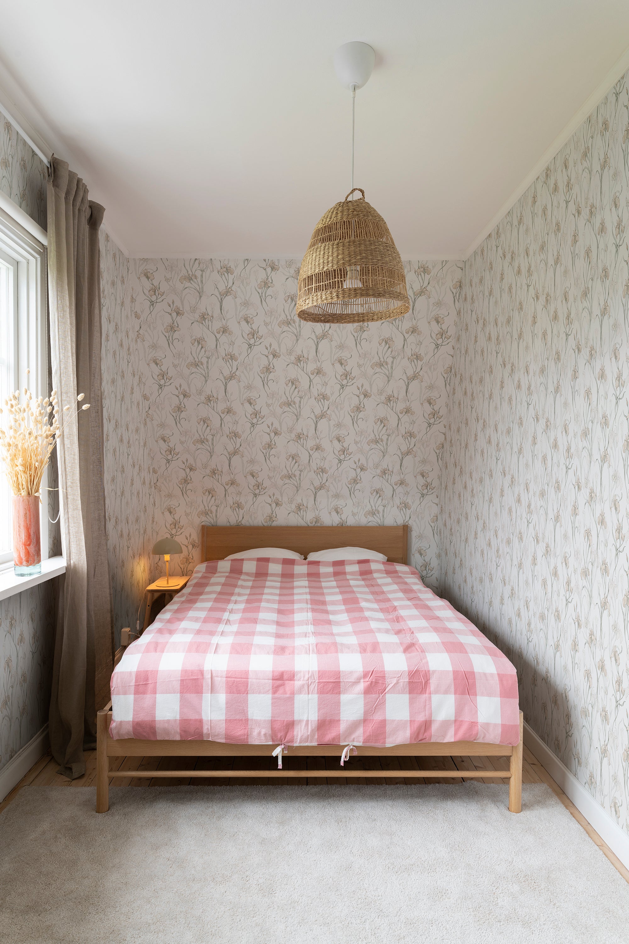 Iris wallpaper by Sandberg in Powder Pink, styled on an interior wall