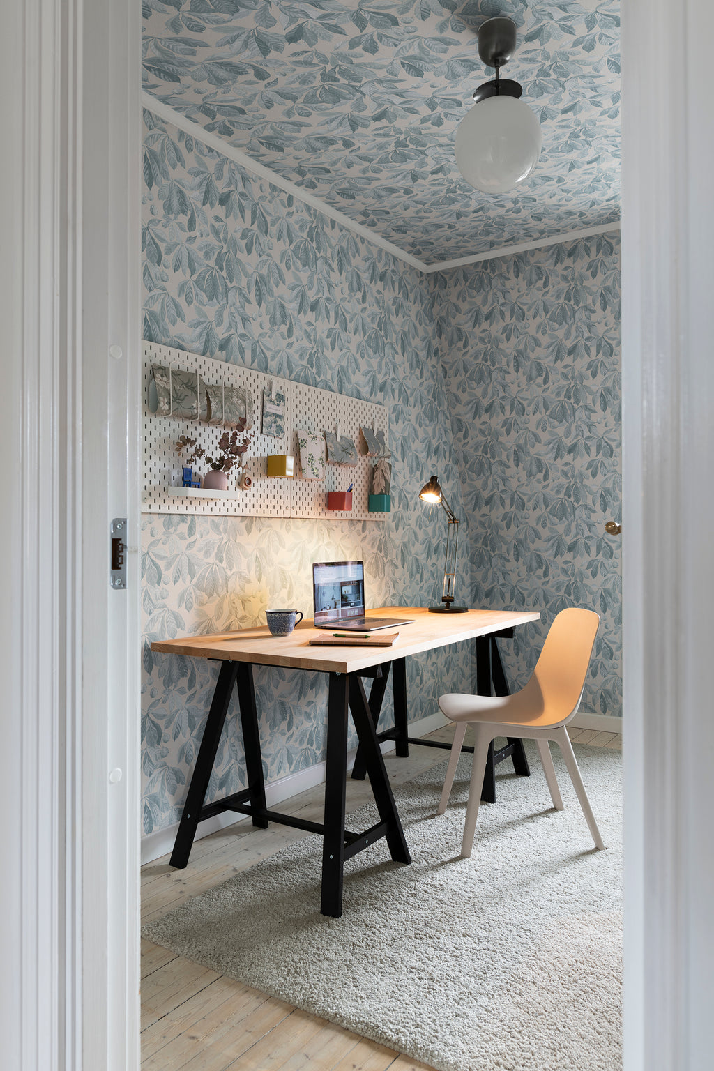Kersti wallpaper by Sandberg in Soft Blue, styled on an interior wall