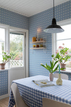 Lyckan wallpaper by Sandberg in Sapphire, styled on an interior wall