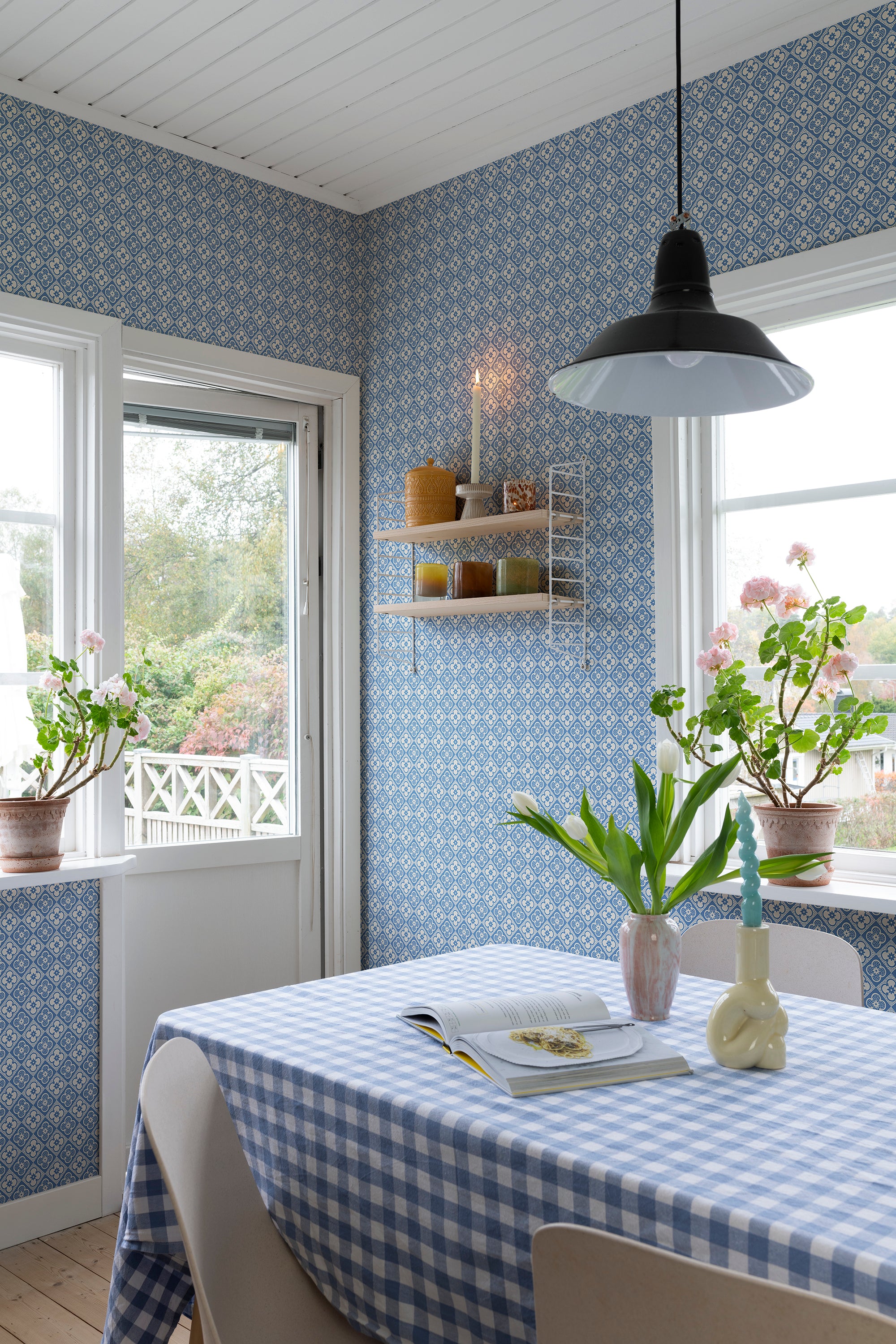 Lyckan wallpaper by Sandberg in Sapphire, styled on an interior wall