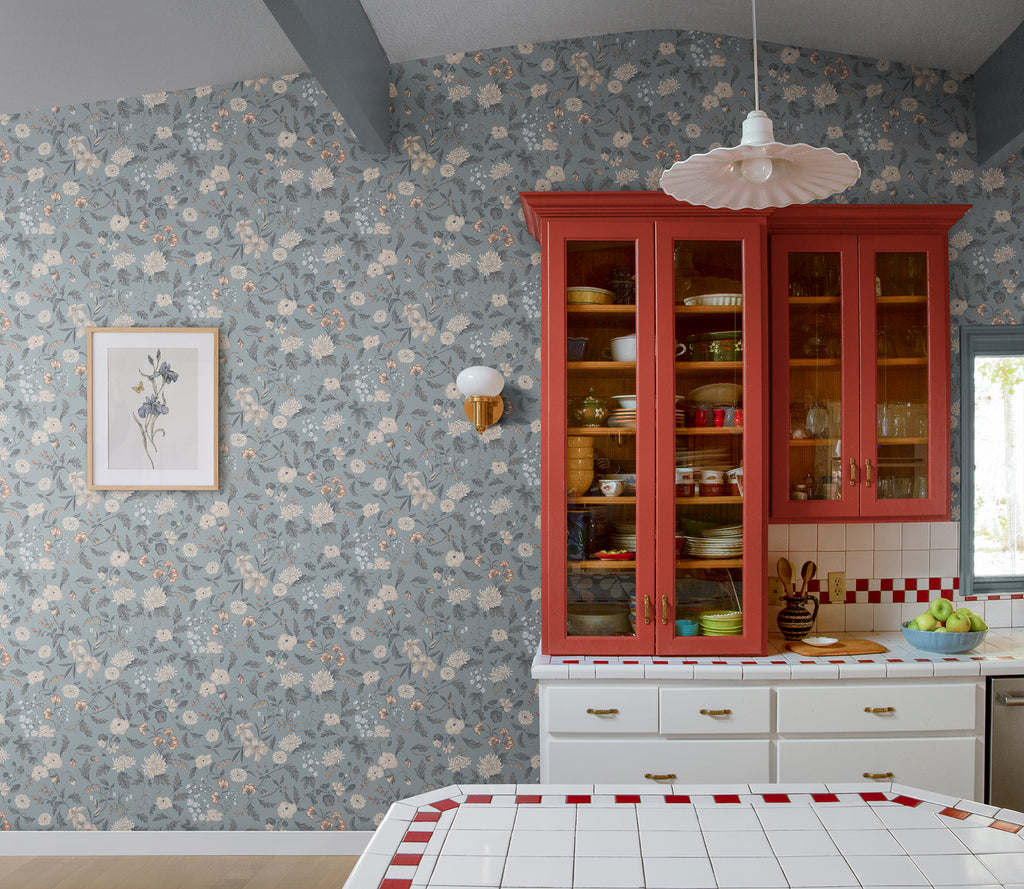 Till Karin wallpaper by Sandberg in dusty blue floral in a country kitchen with red glass-front dresser