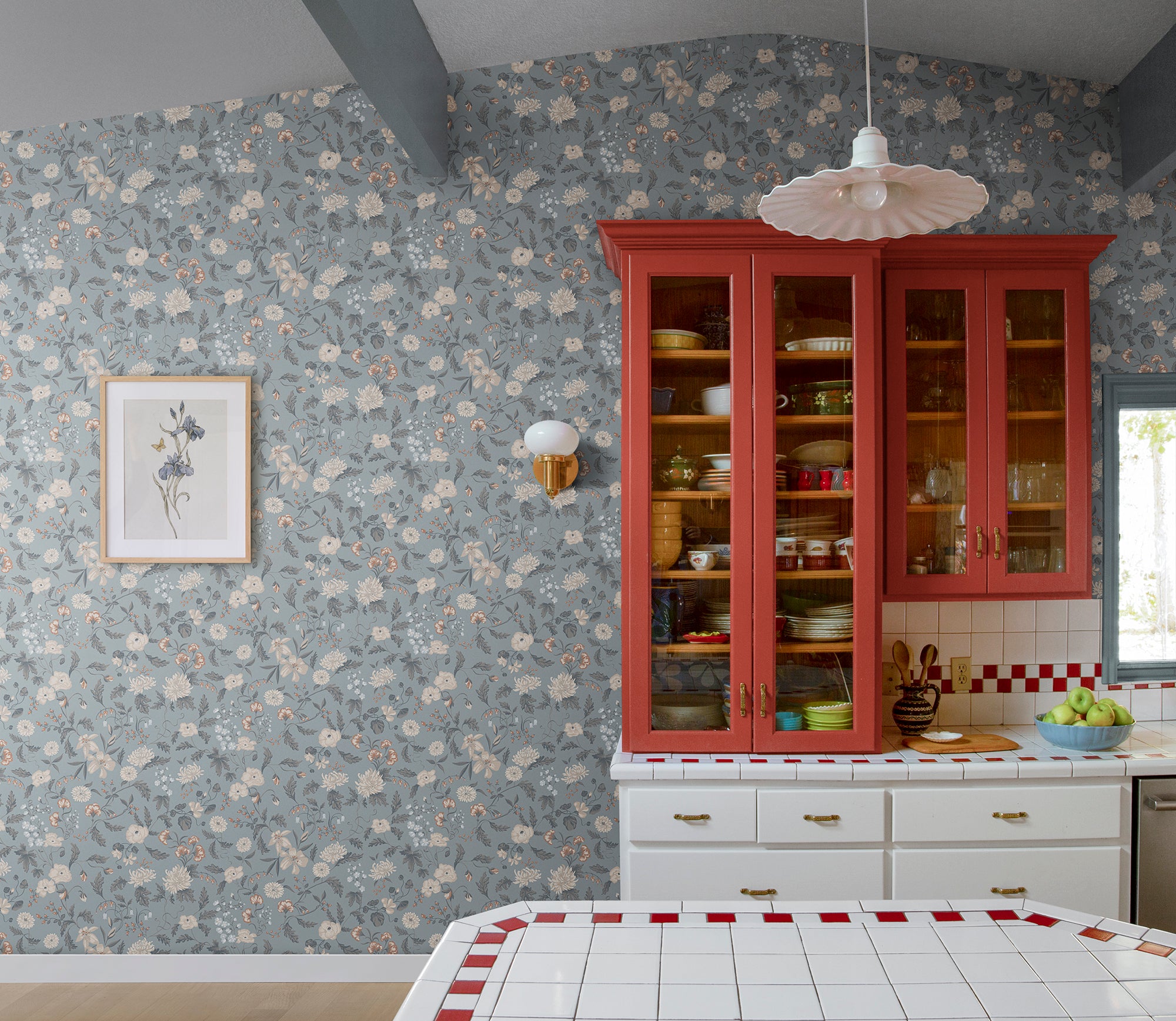 Till Karin wallpaper by Sandberg in dusty blue floral in a country kitchen with red glass-front dresser
