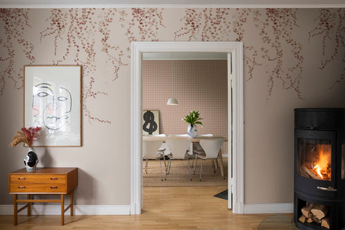 Aralia wall mural by Sandberg in rust, terracotta trailing ivy on beige in a living room with a fireplace